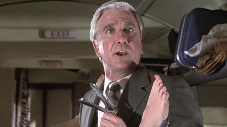 Leslie Nielsen holding medical equipment