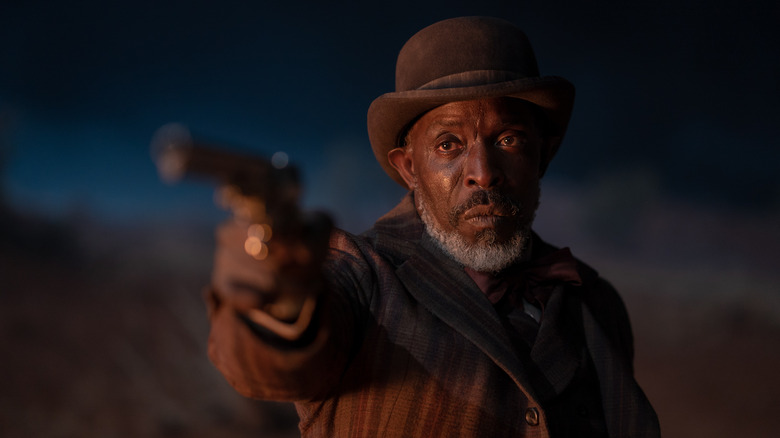 Michael K. Williams as Will Clay holding gun