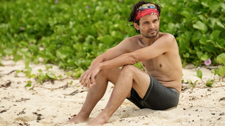 Sean Edwards sitting on beach