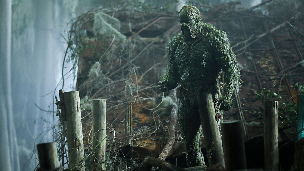 Swamp Thing stands on a rickety dock