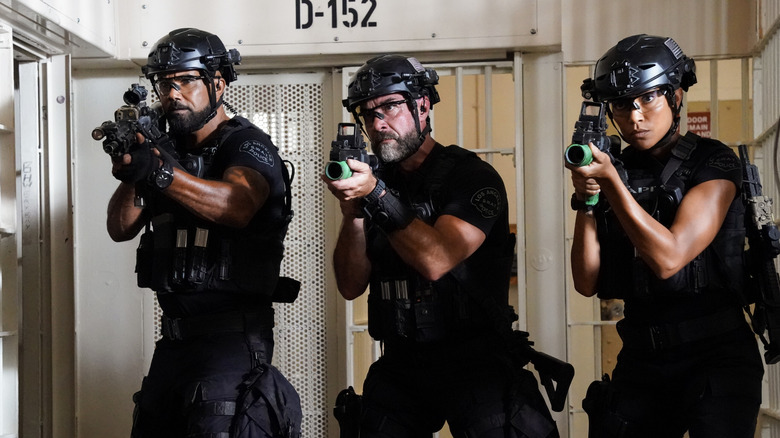 Hondo, Deacon, and Zoe pose with guns