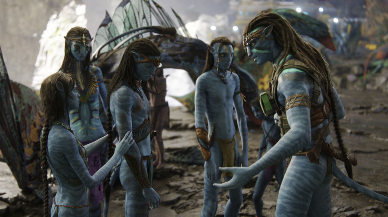 A family of five Na'vi stand in a circle