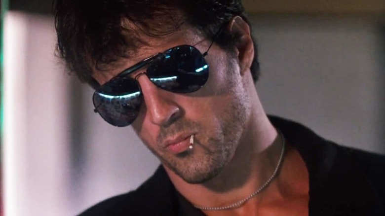 Sylvester Stallone chewing a matchstick 