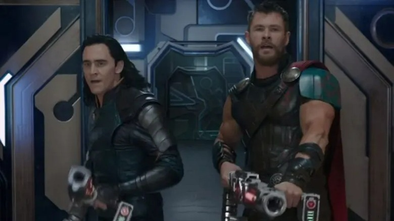 Thor and Loki holding guns