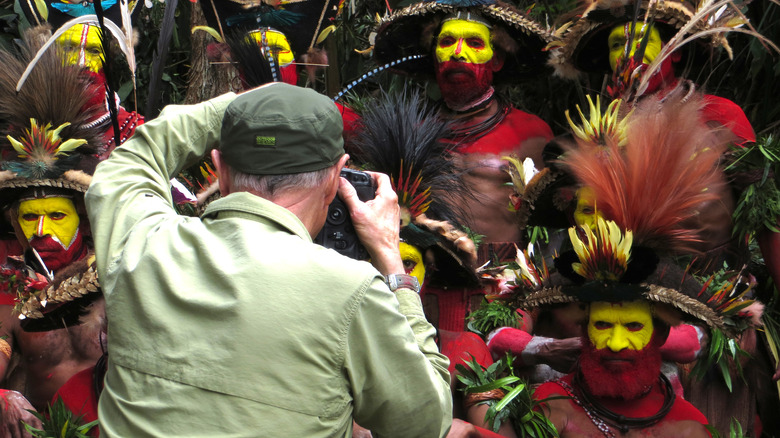 photographer taking picture of native tribe