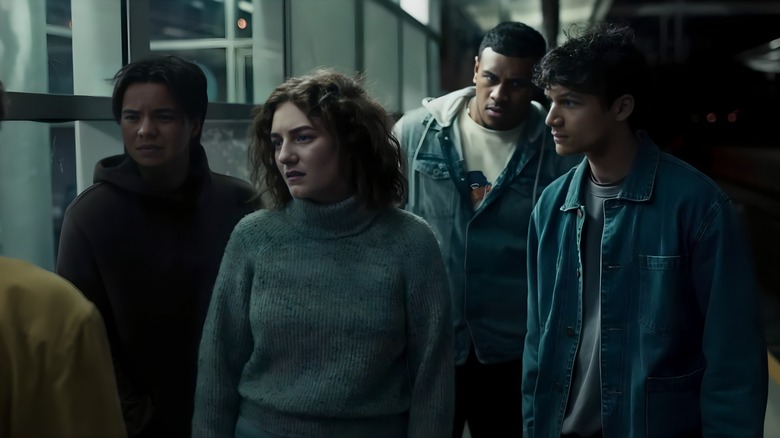 Jade, Hayley, Joss and Daniel staring incredulously at a bus stop