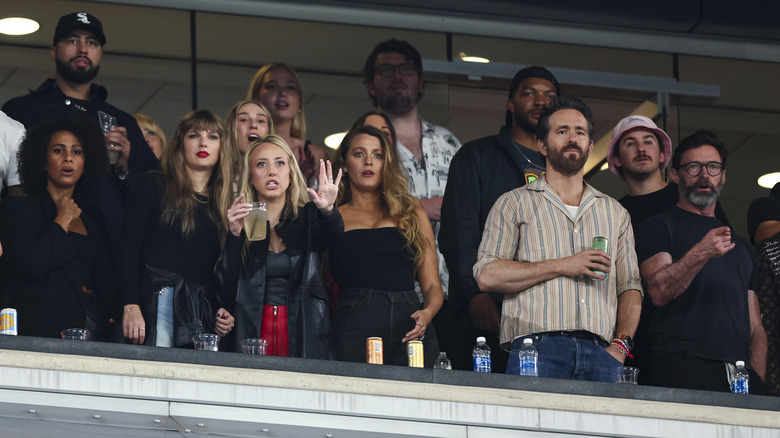 Taylor Swift with Ryan Reynolds and Hugh Jackman at a football game