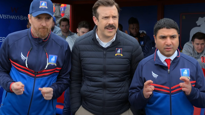 Ted Lasso, Coach Beard, and Nathan Shelley crossing their fingers