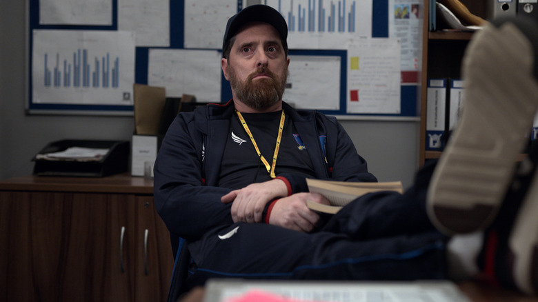 Coach Beard with feet on desk