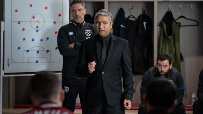 Nate wearing suit in locker room