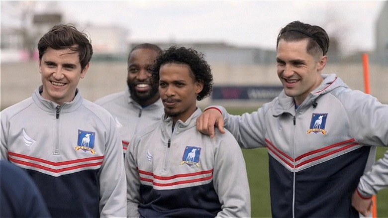 Colin and the team smiling on the pitch