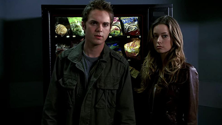 John and Cameron stand in front of vending machine