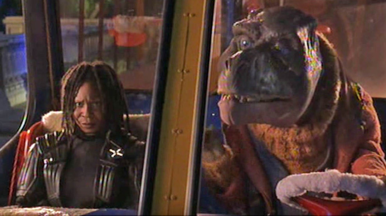 Whoopi sits with a dinosaur