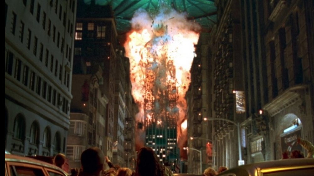 An alien spaceship blows up the Empire State Building, sending debris flying