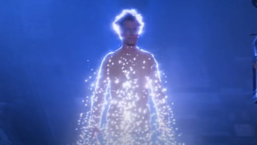 A man stands in a sparkly pyramid of light