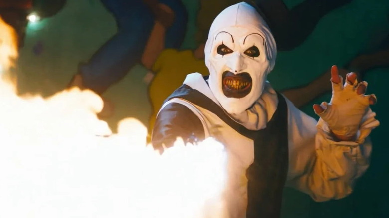 Art the Clown launches flames while grimacing