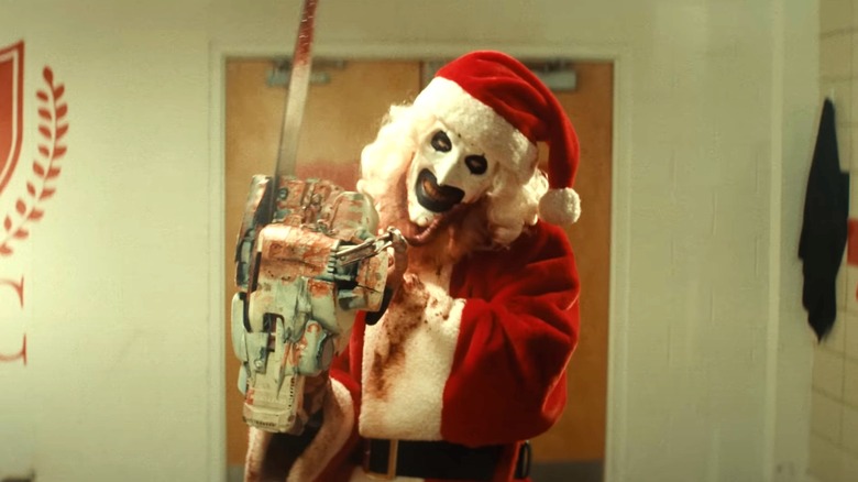 Art the Clown holding chainsaw