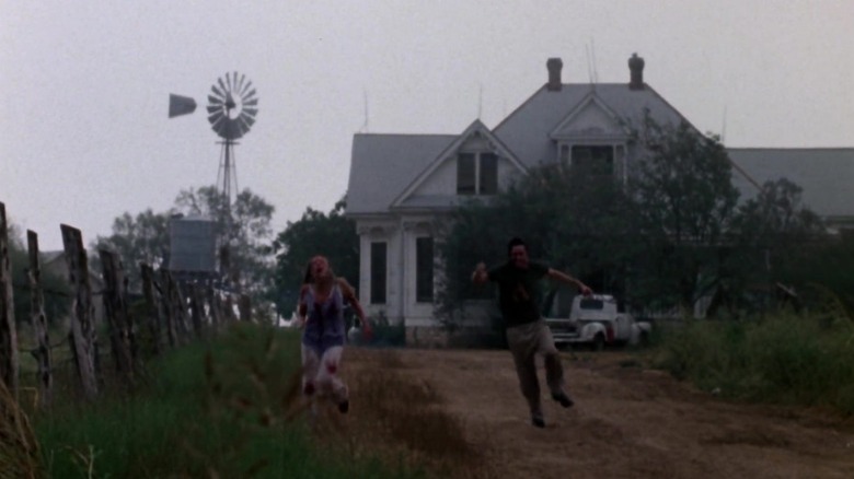 Sally running away from Hitchhiker in front of the Texas Chain Saw house