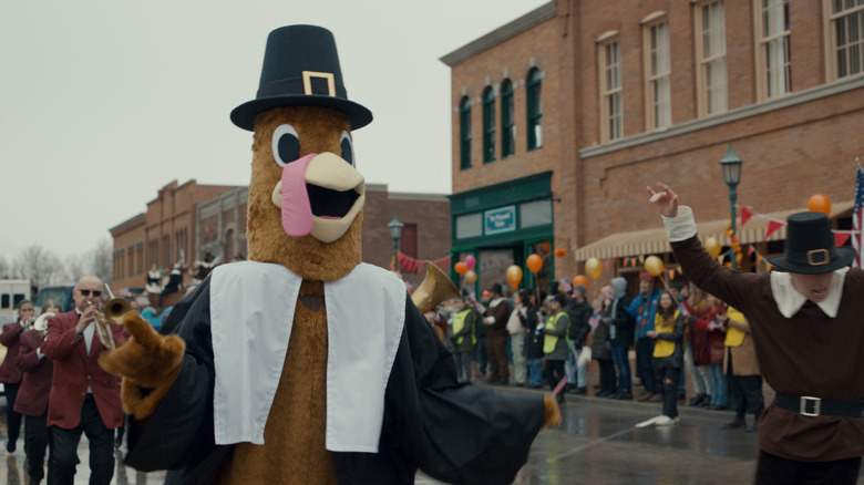 A turkey mascot marches in a Thanksgiving parade