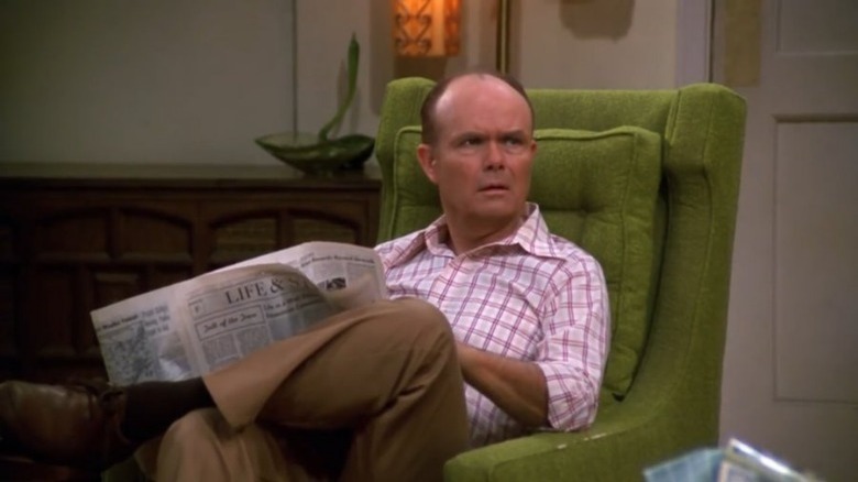 Red seated at chair in That '70s Show