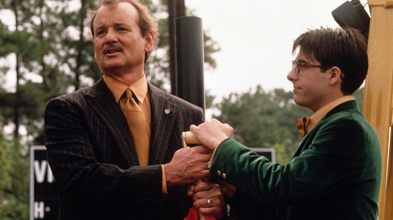 Howard Blume and Max Fischer clutching a shovel