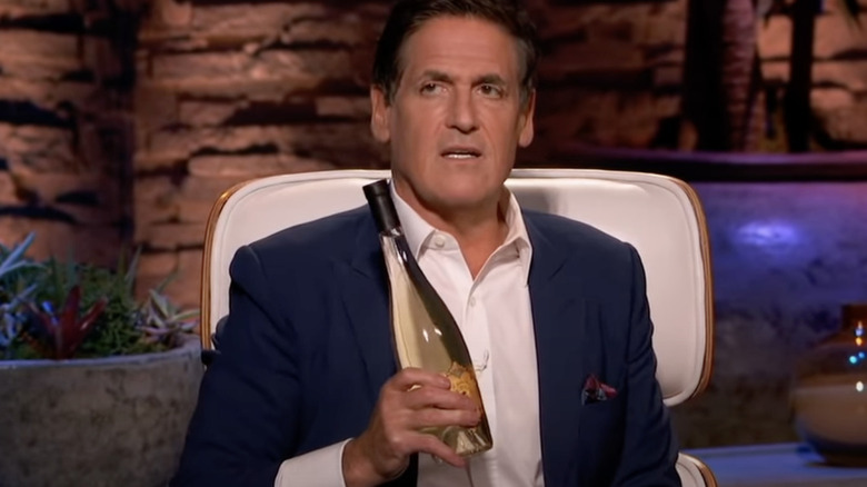 Mark Cuban holds bottle of Bee D'Vine wine on Shark Tank