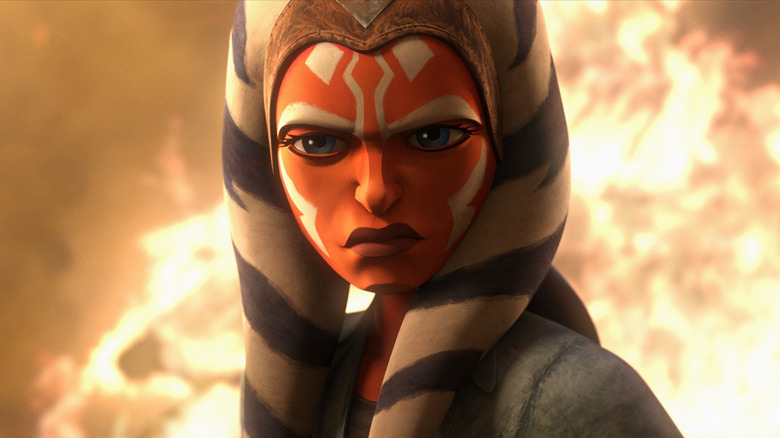 Ahsoka standing in front of flames