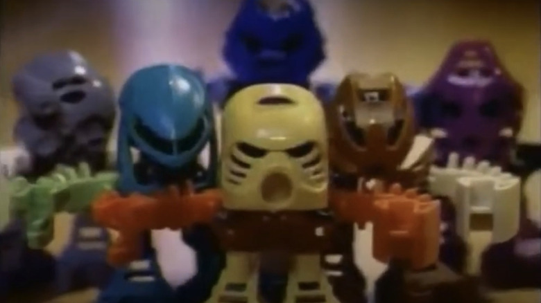 Six Bionicle figures stand together