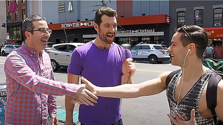 Billy Eichner with John Oliver shaking hands with young man