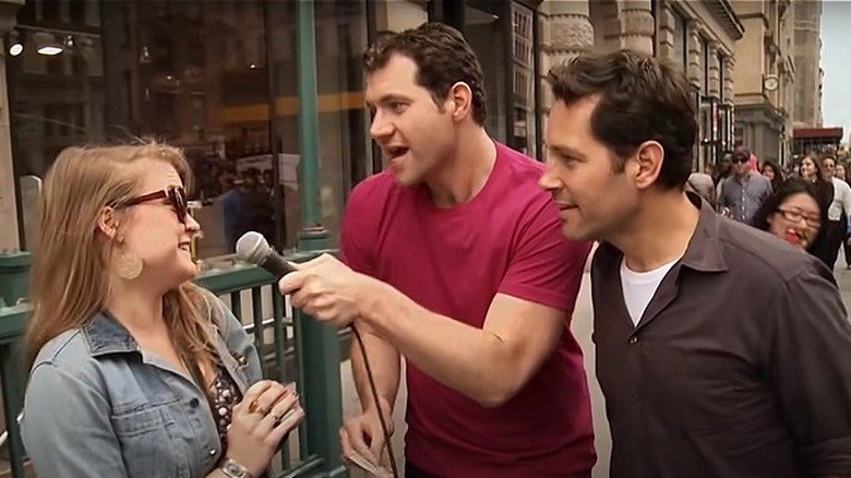 Billy Eichner and Paul Rudd speaking to a woman