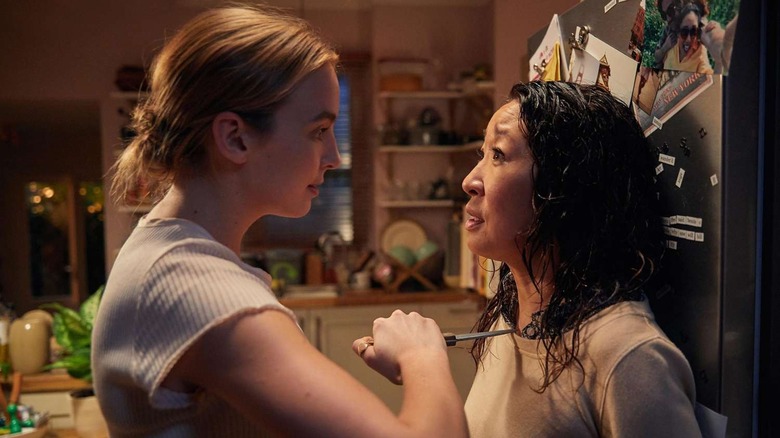 Villanelle holding Eve at knifepoint against a fridge