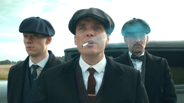 Tommy Shelby smoking cigarette with gang members