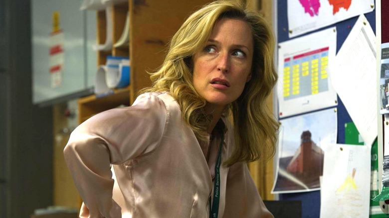 Stella Gibson leaning against a desk in The Fall