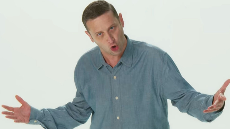 Tim Robinson stares down the camera in front of a white background