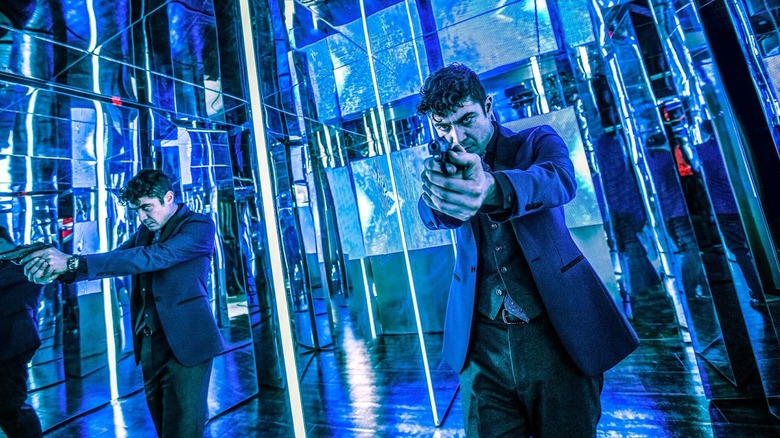 Santino D'Antonio holds gun in hall of mirrors