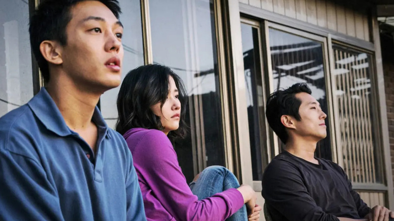 Jong-seo, Hae-mi, and Ben sit on a porch in "Burning" (2018)