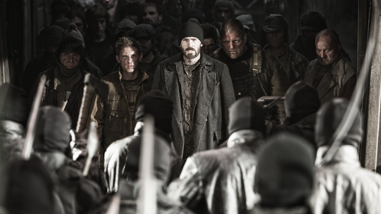 A group of rebels stand in a line ready to fight in "Snowpiercer" (2013)