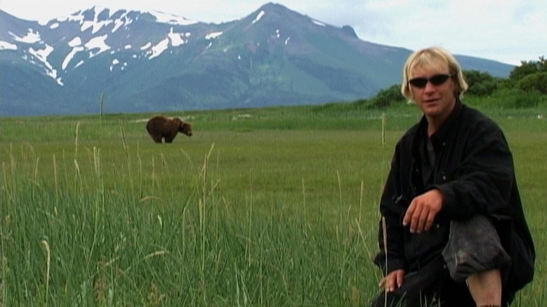 Timothy Treadwell with a bear in the background