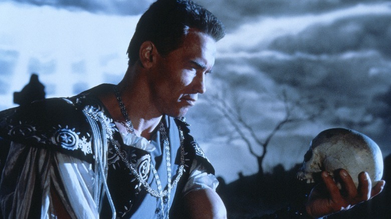 Arnold Schwarzenegger as Hamlet holding a skull