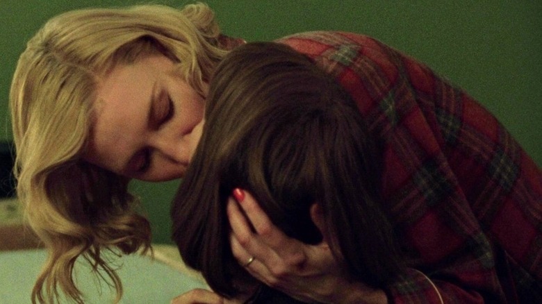 Carol holds Therese's head and kisses her in "Carol" (2015)