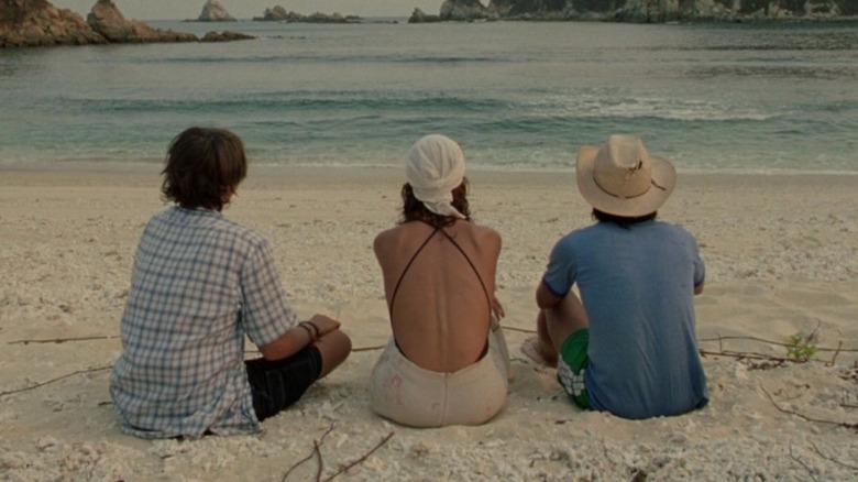 Tenoch, Luisa, and Julio sit on the beach in "Y tu mamá también" (2001)