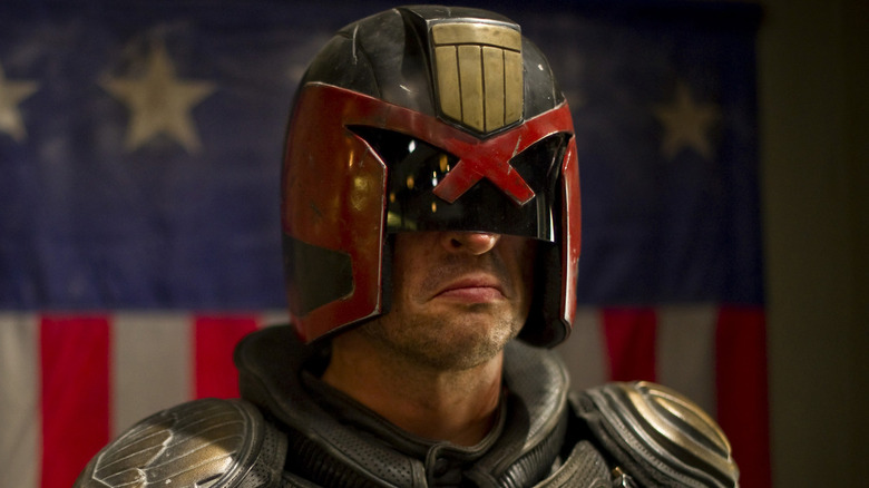 Judge Dredd next to flag