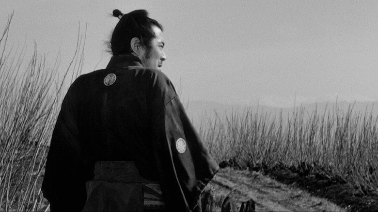 Kuwabatake Sanjuro standing in a field in Yojimbo