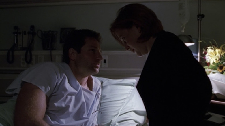 Scully leaning over Mulder