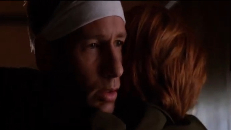 Bandaged Mulder hugging Scully