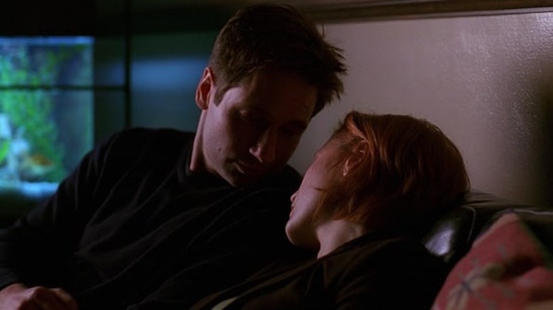 Mulder leaning towards sleeping Scully