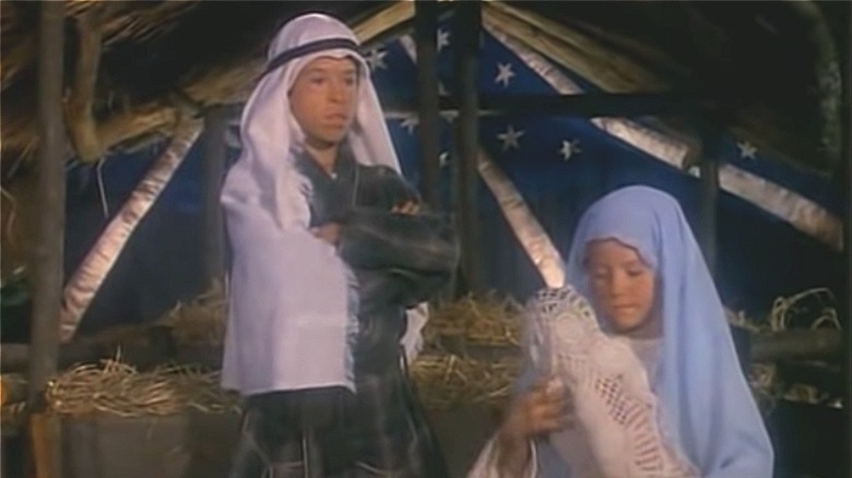 A boy and girl dressed as Mary and Joseph