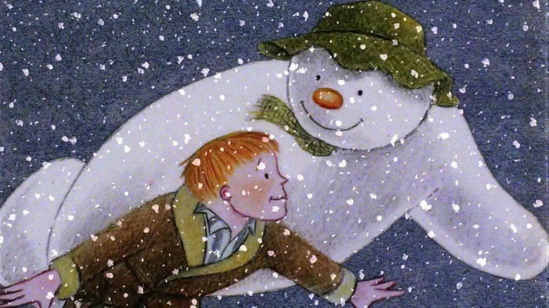 The snowman and the boy flying in the snow