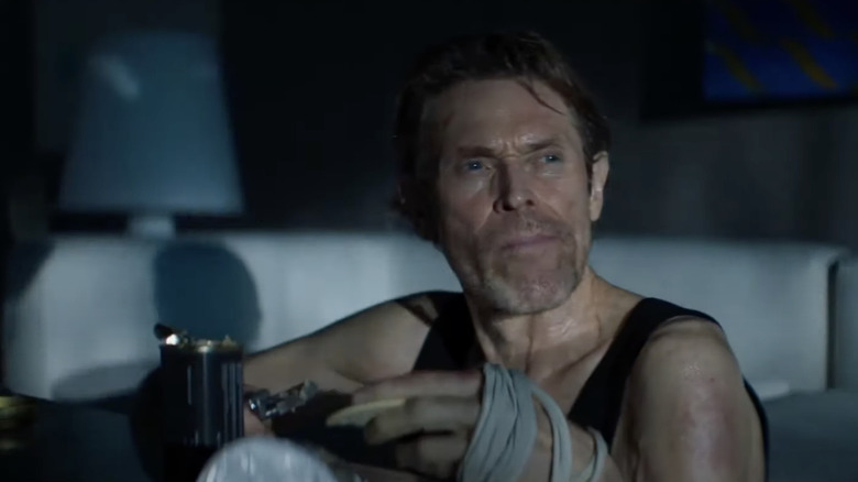 Willem Dafoe knowingly glances