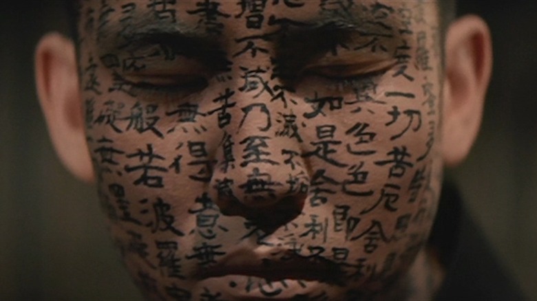 Hoichi covered in calligraphy close-up